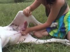 Enjoying the outdoors and rewarding her dog with a cook jerk, this playful dark-haired cougar